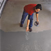Apply the color flakes by sprinkling them lightly onto the epoxy-coated garage floor