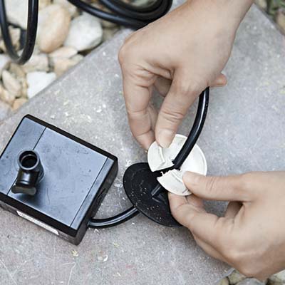 Step 1: Slip the bubbler's cord through slits cut into two rubber plugs