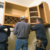 tom silva hanging upper kitchen cabinets with two helpers