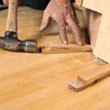 tom silva installing corner base cabinet, ensuring level and adding shims where necessary