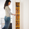 woman hanging cabinet to the anchor system