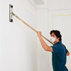 man clearing dust from teh walls