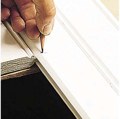 Marking cut lines with a pencil.