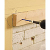 Attaching the cleats using a hammer drill.