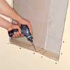 Installing the blocking using a drill.
