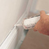 Caulking the gaps before painting a room