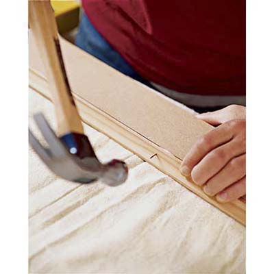 attaching the trim with hammer and nail