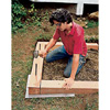 Fastening the frame with rebar, using a sledgehammer.