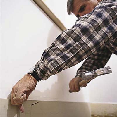 Tom Silva installing baseboard