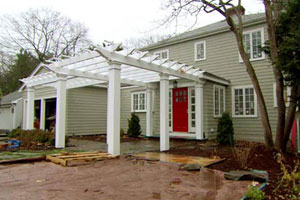 the Auburndale house exterior during renovation, finished pergola