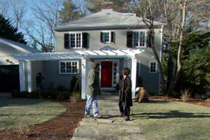 the Auburndale house exterior after renovation, finished pergola and fieldstone walkway