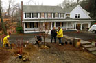Kevin O'Connor and Roger Cook look over the front lawn plantings