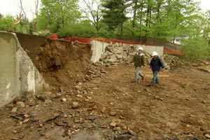 Kevin O'Connor and Tom Silva approach the old foundation at the Weston house project