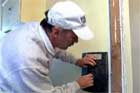 Sal Vaglica stripping wallpaper with a putty knife